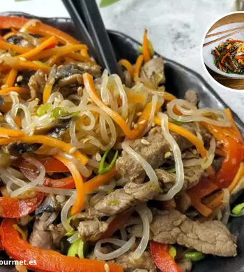 Plato coreano Japchae con fideos de boniato, zanahoria, espinacas, champiñones y ternera, servido en un bol tradicional