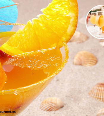 Cóctel Agua de Valencia en un vaso con hielo y decorado con rodajas de naranja.